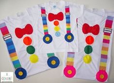 three t - shirts with colorful ties and bows on them, one is made out of white