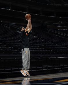 a man is jumping up to dunk a basketball