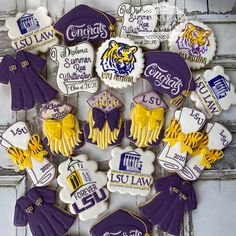 decorated cookies are arranged in the shape of purple and yellow cheerleader's outfits