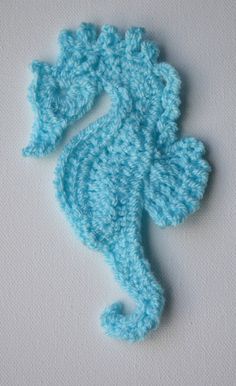 a crocheted seahorse on a white background