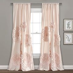 the curtains in this room are decorated with pink flowers and ruffled trimmings