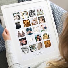 a person holding up a white framed photo