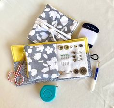 sewing supplies are laid out on a white sheet