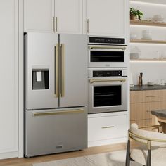 a modern kitchen with stainless steel appliances and white cabinets, along with an area rug on the floor