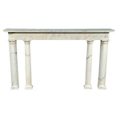 a white marble console table with two columns