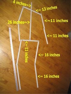 the measurements for an ironing board are shown in yellow and white on a wooden floor