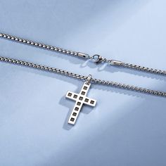 Wear your faith proudly with this men's cross necklace. This beautiful statement piece is crafted in sterling silver with 14k white gold plating and sits on a sturdy 24-inch gold plated stainless steel chain. Gift this bold black cross pendant to him and showcases your faith and belief. Discover all our sleek 925 silver jewelry for men and find a gift for him HERE Made with white gold plated 925 sterling silver. Color: White Dimension: 38 x 25 x 3 mm Length: 60 cm/ 23.6 Inches Chain: 60cm/ 24 In Stainless Steel Cross Pendant Necklace With Box Chain, Stainless Steel Cross Jewelry With Box Chain, Stainless Steel Cross Pendant Jewelry, Tarnish Resistant, Tarnish Resistant Stainless Steel Cross Pendant Jewelry, Tarnish-resistant Stainless Steel Cross Pendant Jewelry, Father's Day Stainless Steel Cross Necklace, Silver Cross Necklace With Box Chain, Father's Day Stainless Steel Cross Pendant Necklace, White Gold Stainless Steel Cross Pendant Necklace