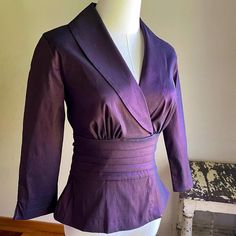 Deep eggplant purple with a gorgeous iridescent sheen. Deep v neckline with shawl collar, 3/4 sleeves with slits, back zip DOWN from just below the collar. Wide attached ties at the pe plated waist. Looks, feels and sounds like silk taffeta, but is 62/32/6 rayon/poly/lycra. The Lycra adds a nice amount of stretch for a flattering fit. By Tadashi, made in USA and tagged a size 4.   Please use the measurements for fit.   Taken flat Pit to pit 16"  Shoulder 15"  Sleeve from shoulder seam 19"  Length from collar seam 21"  Because sizing is not universal among makers or across decades, size numbers are just a starting point. To ensure proper fit, you must measure and compare to a garment that fits you well. There really is no other way. Please be aware, if you need an exact color match, that co Blouse Pattern Sewing, Pattern Sewing, Eggplant Purple, Silk Taffeta, Wrap Blouse, Party Tops, Formal Party, Blouse Pattern, Shawl Collar