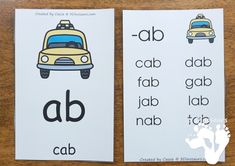 two bookmarks with the words abc and q in front of them on a wooden table