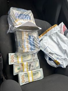 money and plastic bags in the back seat of a car