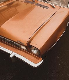 an old car is parked on the side of the road