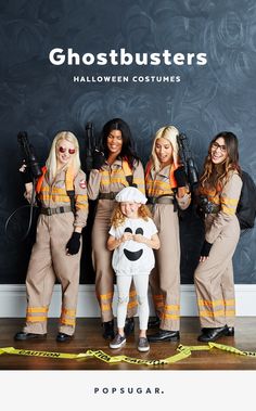 four girls dressed as ghostbusters standing in front of a wall