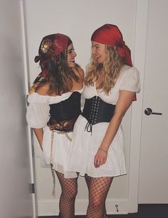 two women dressed in costumes standing next to each other