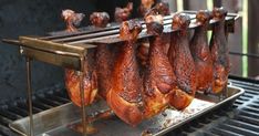 several pieces of meat are being cooked on a bbq with tongs attached to it