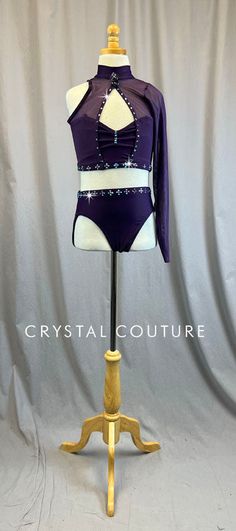 a mannequin wearing a purple and white leotard