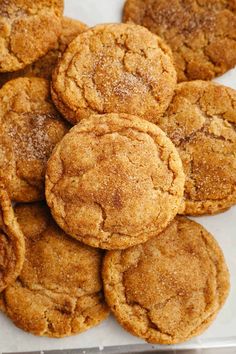 a pile of cookies sitting on top of a white tablecloth covered in powdered sugar