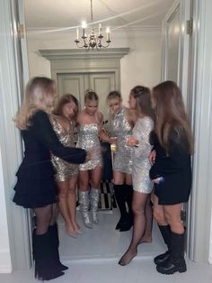 the girls are all dressed up and having fun in the mirror room at the party