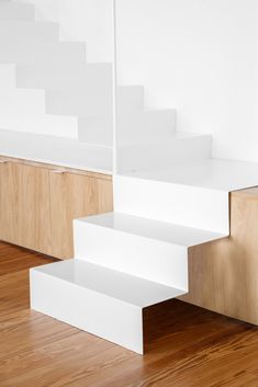 the stairs are made of wood and white paint