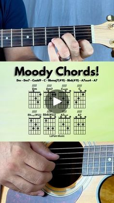 a person holding up a guitar with the words moody chords on it and an image of