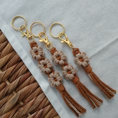 four crocheted tassels are sitting on a piece of cloth next to some scissors