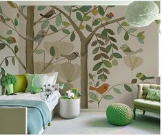 a child's bedroom with a tree mural on the wall