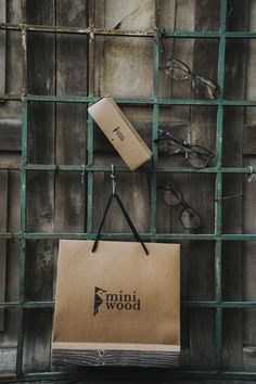 a brown paper bag sitting on top of a wooden table next to eyeglasses