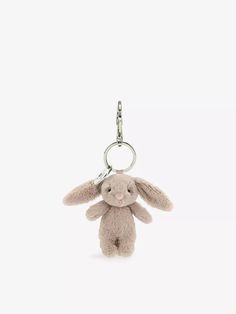 a small stuffed animal keychain hanging from a metal hook on a white background