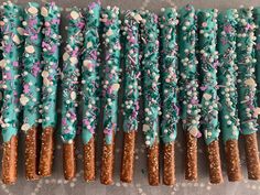 there are many blue and pink pretzels with sprinkles on them