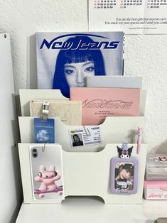 a white shelf with pictures and magnets on it