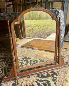 a large mirror sitting on top of a rug