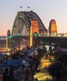 the city is lit up at night with lights shining on it's bridges and buildings