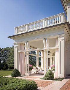 a large white house with an open porch