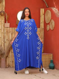 "An elegant Moroccan caftan will make you feel like African royalty. It's extremely elegant with a dash of classy cotton embroidery in the front. Ideal for plus size women as well. Made of extremely soft fabric to make you feel free and beautiful at the same time.  This Kaftan is ideal to wear for any casual occasion. Whether taking a trip down the shopping lane, or home-based kitty parties, or about anything else, wearing this dress will make you feel classy and comfortable. Fabric : 70% Egyptian cotton and 30% polyester Size : Free sized dress. Fits up to a 6XL US.  Kaftan Measurements : Bust and hips - 64 inches Length : 52 inches (130 cm).  For reference the model is a size Medium (8 US) and 5'5\". As you can see the caftan fits her quite loosely which is the way it's meant to be. It i Luxury Blue Women's Thobe, Free Size Tunic Abaya, Traditional Free Size Tunic Thobe, Floral Embroidered Kaftan For Festivals, Traditional Long Free Size Kaftan, Embroidered Short Sleeve Kaftan For Eid, Blue Embroidered Short Sleeve Kaftan, Free Size Blue Kaftan For Eid, Blue Free Size Kaftan For Eid