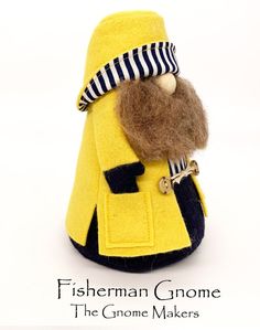 a stuffed toy is dressed in a yellow coat and hat with a beard, striped scarf, and mustache