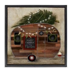 a wooden trailer with christmas decorations and lights on the front is framed in black wood