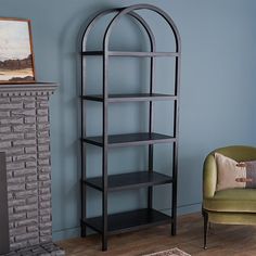 a living room with a fireplace, chair and bookcase