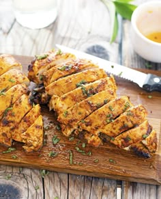 sliced up chicken on a cutting board with a knife