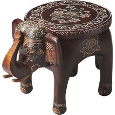 an elephant shaped wooden stool with intricate designs