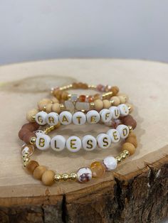 Our PUMPKIN SPICE stack! These are super stylish, comfortable and perfect for FALL! Such a trendy boho-look! (These are meant to fit snug. If you would like them to feel loose and move around on your wrist, please size up). Each bracelet is carefully handmade with high quality materials: -6mm natural Agate stones in Fall colors -6mm natural wood beads -3mm gold hematite beads -7mm black/gold acrylic letters -Cord: high-quality, durable, stretch cord with reinforced knots and specialty glue ⭐️⭐️W Everyday Bohemian Personalized Beaded Bracelets, Everyday Personalized Bohemian Bracelets, Bohemian Gold Bracelets With Letter Beads, Gold Bohemian Bracelets With Letter Beads, Bohemian Gold Stretch Bracelet With Wooden Beads, Trendy Brown Beaded Bracelets For Everyday, Bohemian Gold Beaded Bracelets With Letter Beads, Gold Bohemian Beaded Bracelets With Letter Beads, Trendy Brown Beaded Bracelets