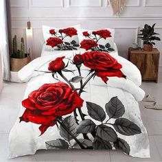 a bed with red roses on it in a room next to a potted plant