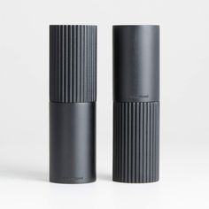 two black cylindrical objects sitting next to each other