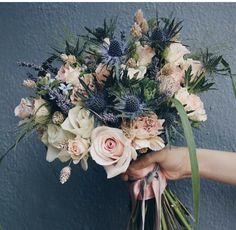 a person holding a bouquet of flowers in their hand