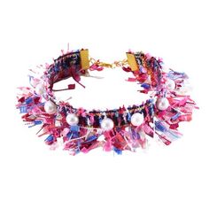 a pink and blue bracelet with pearls on the bottom, beads hanging from it's sides