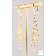 You will look so pretty in these Pink Glass Filigree Drop Earrings! Enhance your beauty with these Pink Glass Filigree Earrings! Sweet and elegant these stunning earrings are a must-have for any wardrobe, featuring lovely faceted pink briolette glass beads, micro-faceted white glass beads, and gold seed beads. The gold-plated filigree and lever backs add a touch of elegance to these 2.75 inch long earrings. Perfect for adding a touch of romance and charm to your look, these gold filigree dangle