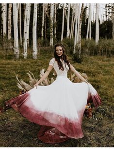 a woman in a white and red dress posing for a photo