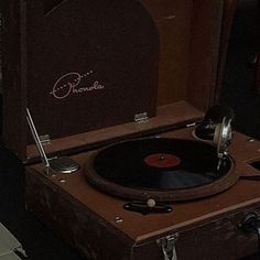 an old record player sitting in a suitcase