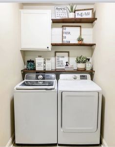 a white washer and dryer sitting next to each other in a laundry room