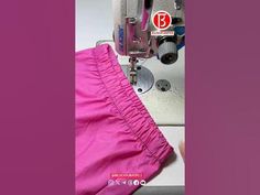 the sewing machine is working on the pink pants