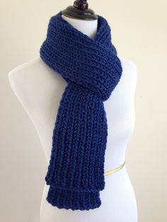 a blue knitted scarf on a mannequin