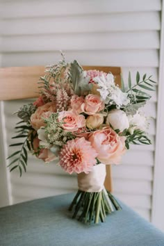 a bouquet of flowers sitting on top of a chair